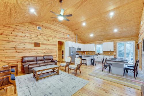 a living room with a couch and a table at Private Deck and Forest Setting Waelder Cabin! in Waelder