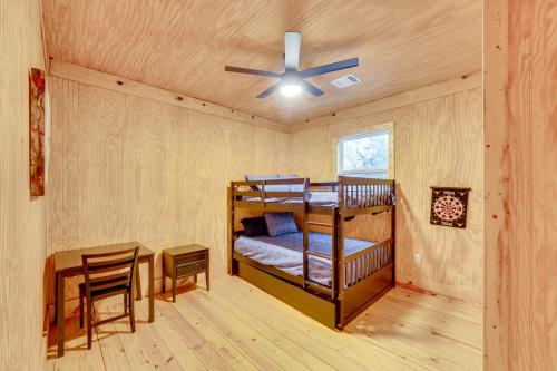 a room with two bunk beds and a table at Private Deck and Forest Setting Waelder Cabin! in Waelder
