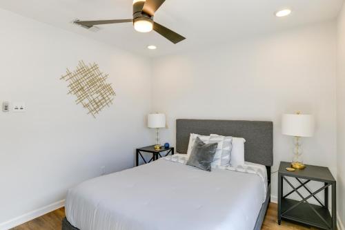 a bedroom with a white bed and a ceiling fan at Lakefront Home with Dock and Patio in San Angelo! in San Angelo