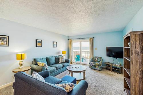 a living room with a couch and a tv at Skip 713 RR in Rodanthe