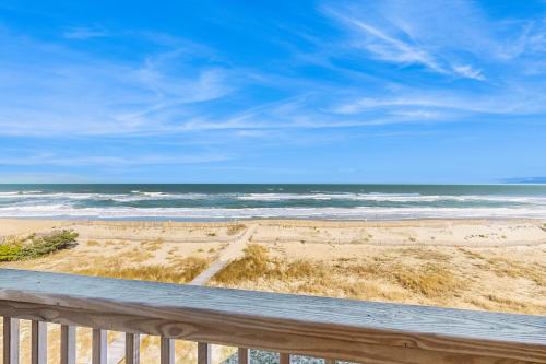 a view of the ocean from a balcony of a beach at Skip 713 RR in Rodanthe