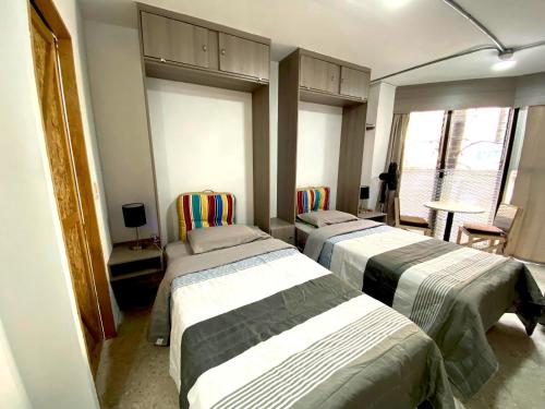 a room with three beds in a room at Estudios by Flor y tierra in Guadalajara