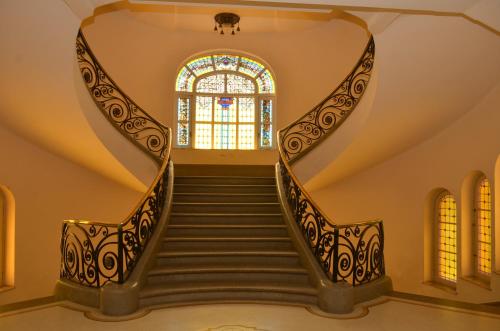 a spiral staircase with a stained glass window at Argentino Hotel Casino & Resort in Piriápolis