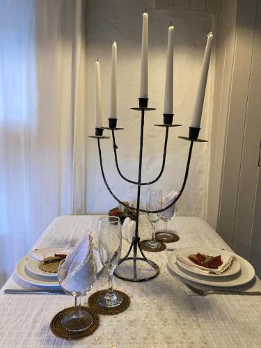 a table with candles and plates of food on a table at Cosy Seaside Cottage Baltimore in Ballylinchy