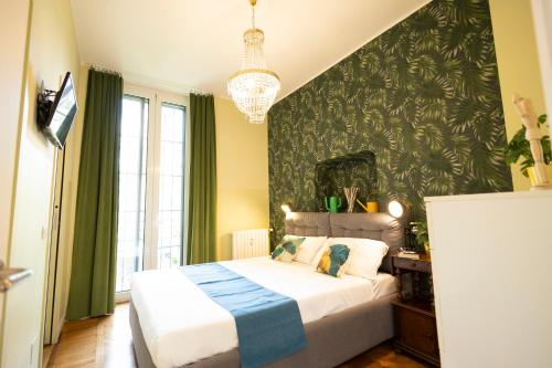 a bedroom with a bed and a green wall at Vittadini Rooms in Milan