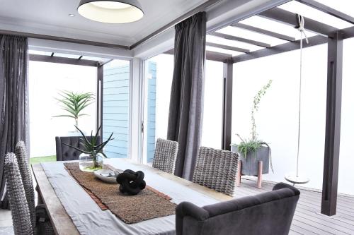 a dining room with a table and chairs at 4on Pebbles Holiday Home in Swakopmund