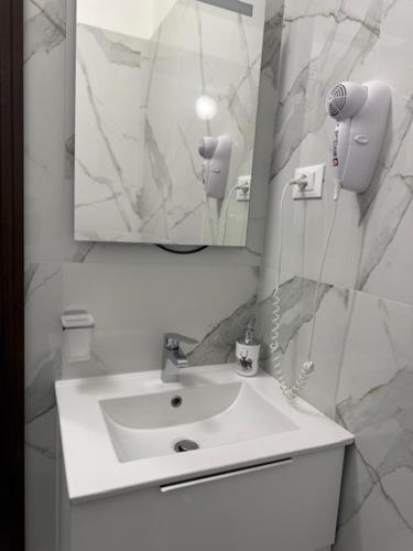 a white bathroom with a sink and a mirror at Ca Aisha Train Station Venice in Mestre