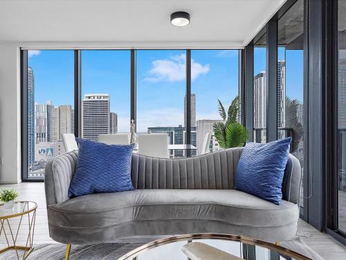 a living room with a couch and large windows at X Lounge IV-Skyline Corner Residence in Miami
