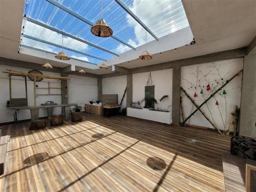 a large room with a wooden floor and a large window at Getaway to Mauritius - Évasion à Île Maurice in Eau Bleue