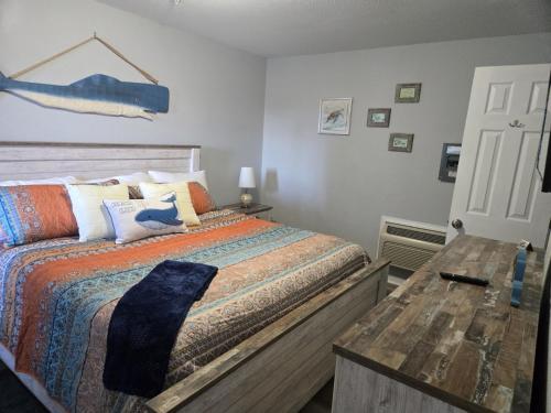a bedroom with a bed and a wooden table at Pirates Cove in Carolina Beach