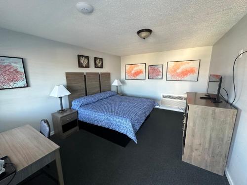 a hotel room with a bed and a table at Pirates Cove in Carolina Beach