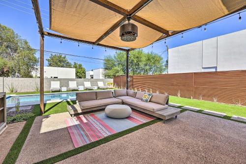 a living room with a couch and a pool at Backyard Oasis with Pool! Family Getaway in Phoenix in Phoenix
