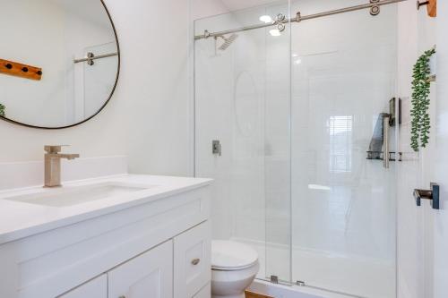 a white bathroom with a sink and a shower at Close to Canyon Lake Cabin - Boat Ramp and Hot Tub in Canyon Lake
