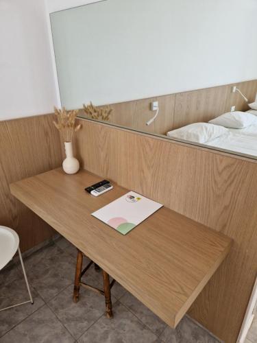 a wooden table in a room with a bed at Sea View Luxury Studios in Vrachonisída Palaiókastro