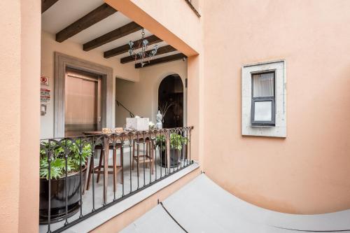 a balcony of a house with a table and chairs at Artesana - Privately Owned Rosewood Residence in San Miguel de Allende