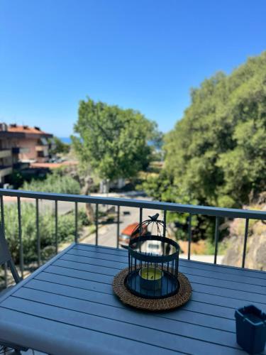 a table with a candle on top of a balcony at Mare Apartment 4 in Scalea