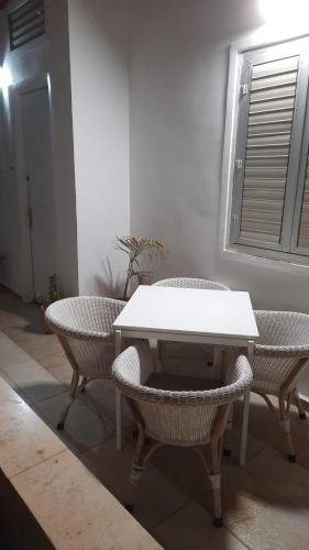 a white table and two chairs and a table and a window at נוף במגדל in Migdal