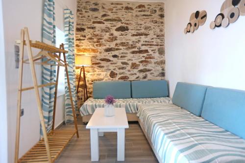 a living room with a couch and a table at Thealos view in Ermoupoli