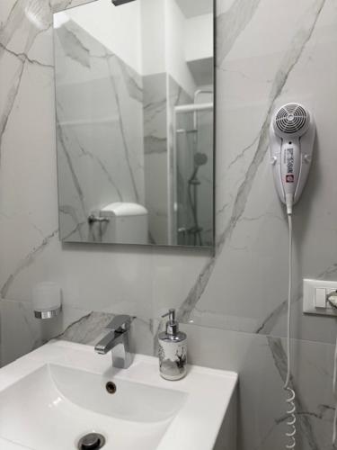 a white bathroom with a sink and a mirror at Ca Aisha Train Station Venice in Mestre