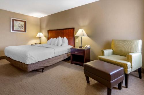 a hotel room with a bed and a chair at Best Western Plus Inn at Hunt Ridge in Lexington