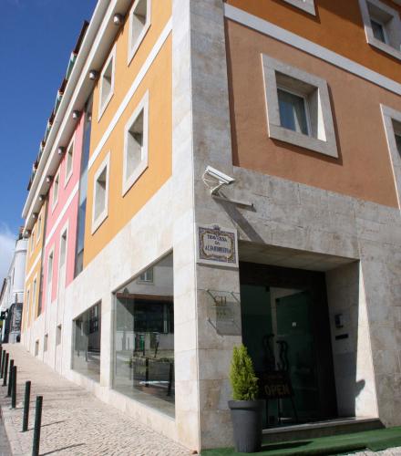 a building on a street with glass windows at Cascais Hotel in Cascais