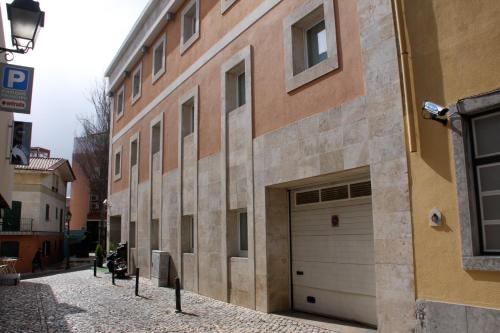 a building with a garage on the side of a street at Cascais Hotel in Cascais