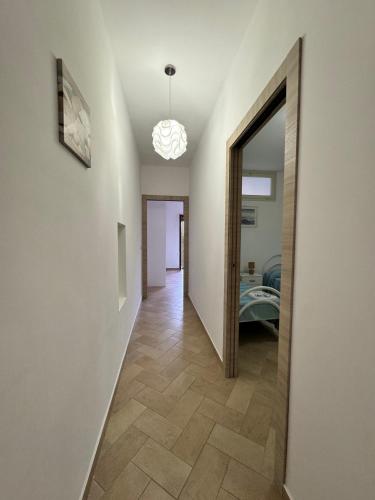 a hallway leading to a room with a mirror at Mare Apartment 4 in Scalea