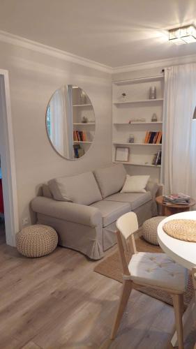 a living room with a couch and a mirror at Apartament nad Zalewem All-Inclusive in Serock