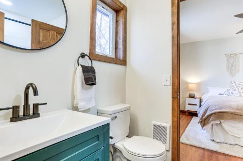 a bathroom with a sink and a toilet and a bed at Pocono Mountain Family Home with Deck and Grill in Saw Creek