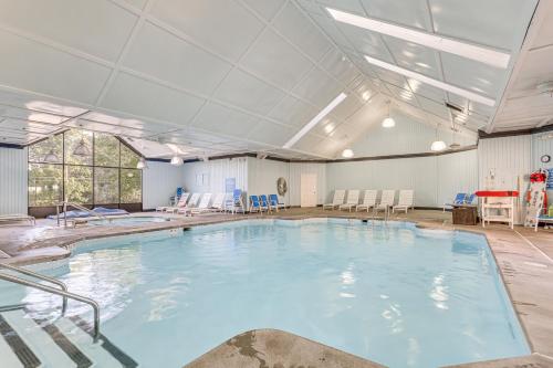 a large indoor swimming pool with blue water at Pocono Mountain Family Home with Deck and Grill in Saw Creek