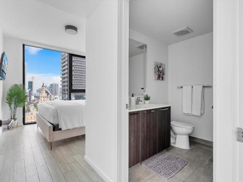 a bedroom with a bed and a sink and a toilet at X-Lounge - High-Rise with Rooftop Pool & Panoramic City Views in Miami