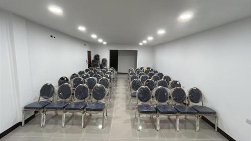 a row of chairs in a room with white walls at Mar Inn Hotel in Ríohacha