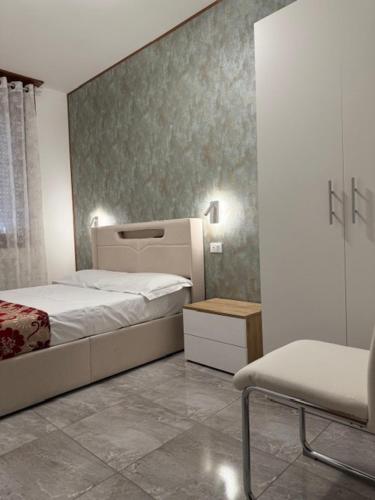 a small bedroom with a bed and a chair at Ca Aisha Train Station Venice in Mestre