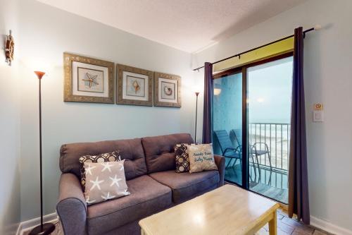 a living room with a couch and a table at Plantation Dunes #5404 in Gulf Highlands