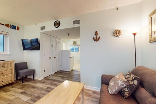 a living room with a couch and a table at Plantation Dunes #5404 in Gulf Highlands