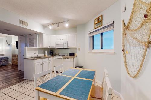 a kitchen and dining room with a table and chairs at Plantation Dunes #5404 in Gulf Highlands