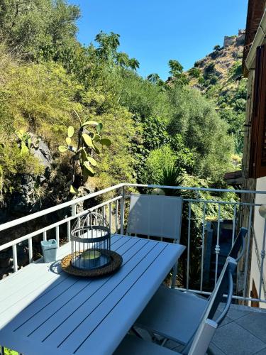 a deck with a table and chairs on a balcony at Mare Apartment 4 in Scalea
