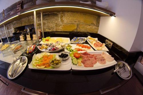 a buffet with many plates of food on a table at Hotel Enztal Garni in Bietigheim-Bissingen