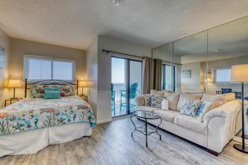 a bedroom with a bed and a couch at Plantation Dunes #5801 in Gulf Highlands