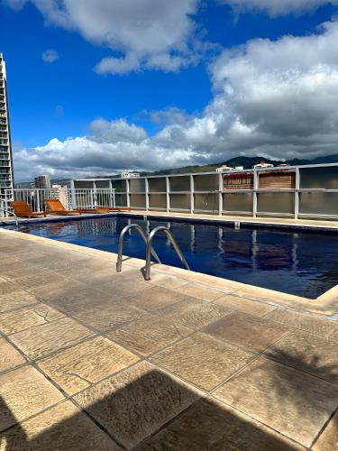 a swimming pool on the roof of a building at Renovated Studio Free Parking in Prime Waikiki in Honolulu