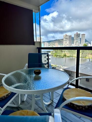 a table and chairs on a balcony with a view at Renovated Studio Free Parking in Prime Waikiki in Honolulu
