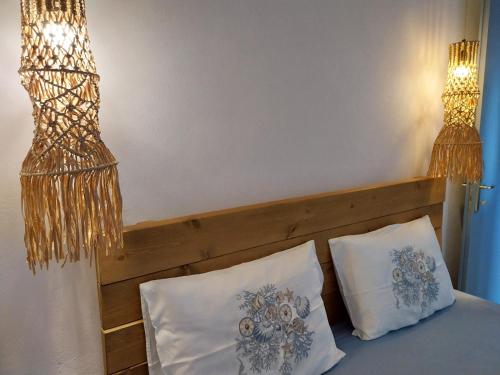 a bedroom with a bed with two pillows and two lights at Galazio Seaside Luxury Rooms & Coffee Shop in Platamonas