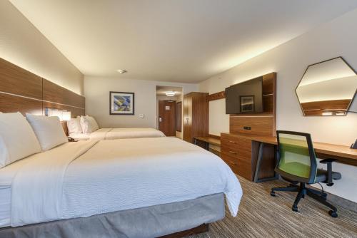 a hotel room with a bed and a desk at Holiday Inn Express & Suites - Manitou Springs by IHG in Manitou Springs