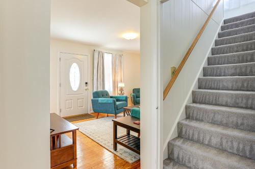a living room with a staircase and blue chairs at 13 Mi to Downtown Baltimore Quiet Home with Porch in Middle River