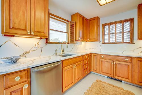 a kitchen with wooden cabinets and a sink at 2 Mi to Stone Harbor Beach Lovely Bayfront Home in Cape May Court House