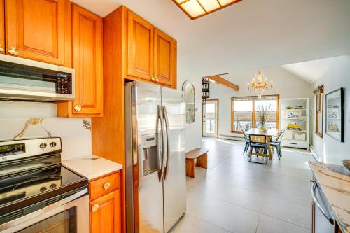 a kitchen with wooden cabinets and stainless steel appliances at 2 Mi to Stone Harbor Beach Lovely Bayfront Home in Cape May Court House