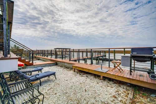 a deck with benches and a piano on the beach at 2 Mi to Stone Harbor Beach Lovely Bayfront Home in Cape May Court House