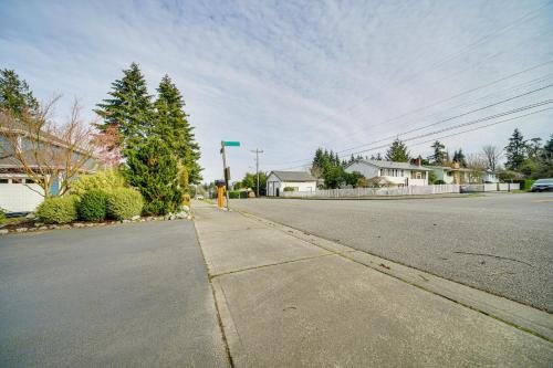 an empty street in a residential neighborhood with houses at 2 Mi to Burien Peaceful Studio with Deck! in Burien