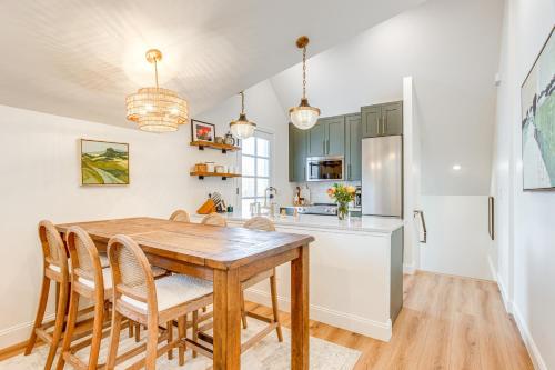 a kitchen and dining room with a wooden table and chairs at Luxe Designer Flat on Sloans Lake with Rooftop Deck in Denver