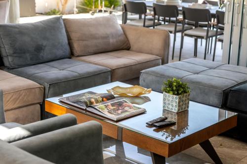 a living room with couches and a coffee table at Fig Tree Bay Residences 7 in Protaras
